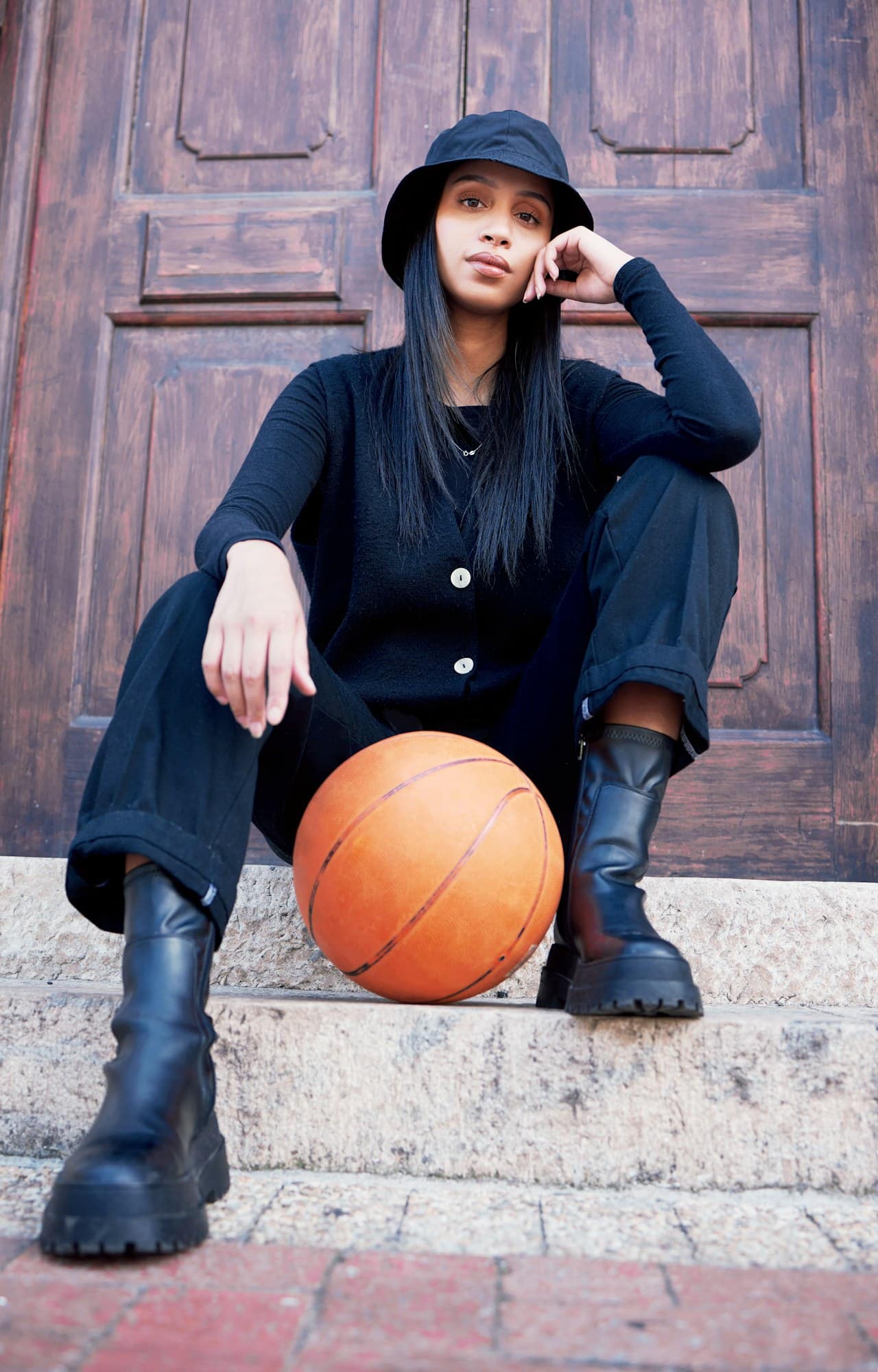 Basketball, fashion and model influencer of a woman posing on steps in an urban city with fashionab